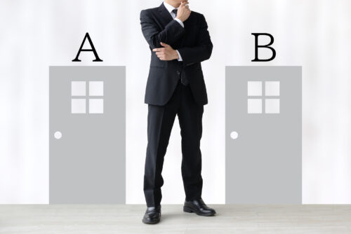 Standing businessman and two doors with A and B word