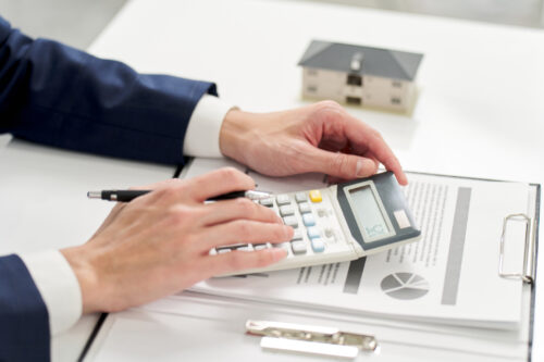 Businessman calculating money related to real estate