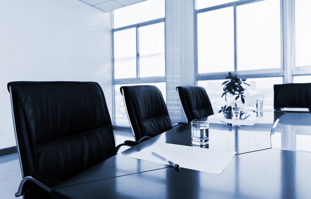 White paper with pen in meeting room.