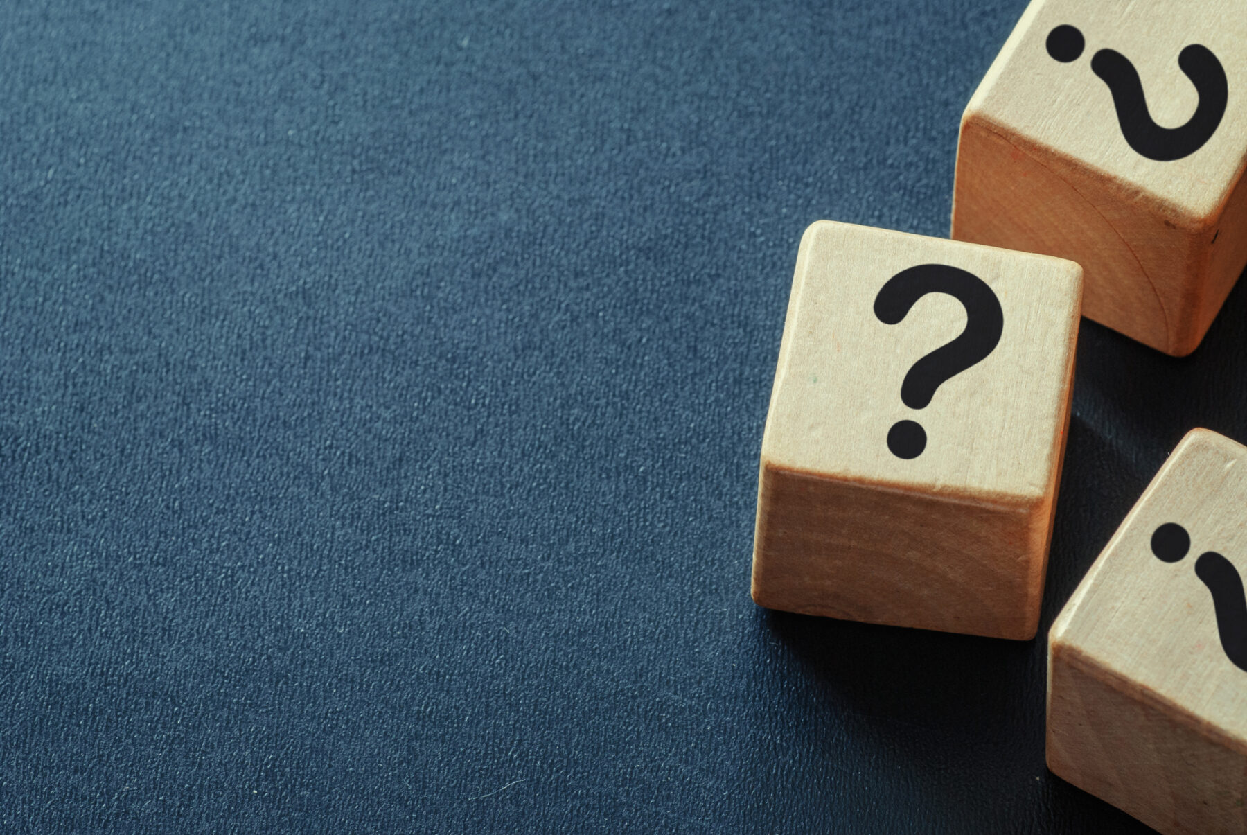 Side border of question marks on wooden cubes
