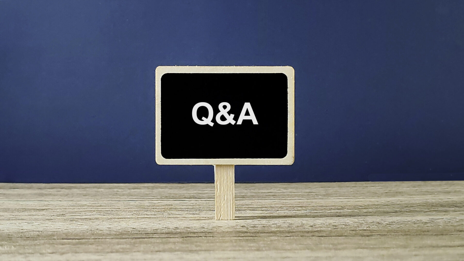 Q&A Sign on Miniature Blackboard on Wooden Table for Questions and Answers Concept